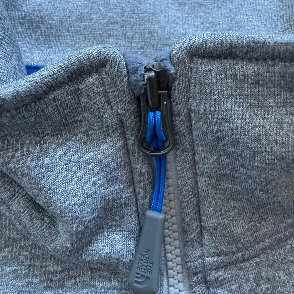 The North Face Men’s gray quarter zip with blue details.  Size medium